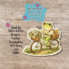 Cozy Cottagecore Frog Sticker, Frog riding a bike die cut sticker