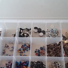 Scrapbooking Embellishments Lot Brads Eyelets in plastic storage box