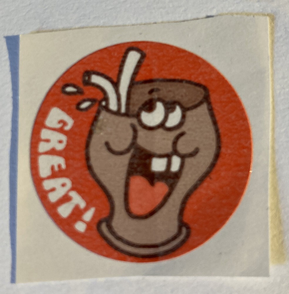 Vintage 1980’s scratch n sniff 1.5” matte circle sticker. Great! Choc shake