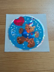 Vintage 1986 Sandylion large 3” circle prism sticker of Birthday bear & Frisbee