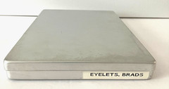 #1 – METAL CASE w/ 40 METAL CONTAINERS of SCRAPBOOKING EMBELLISHMENTS – EYELETS