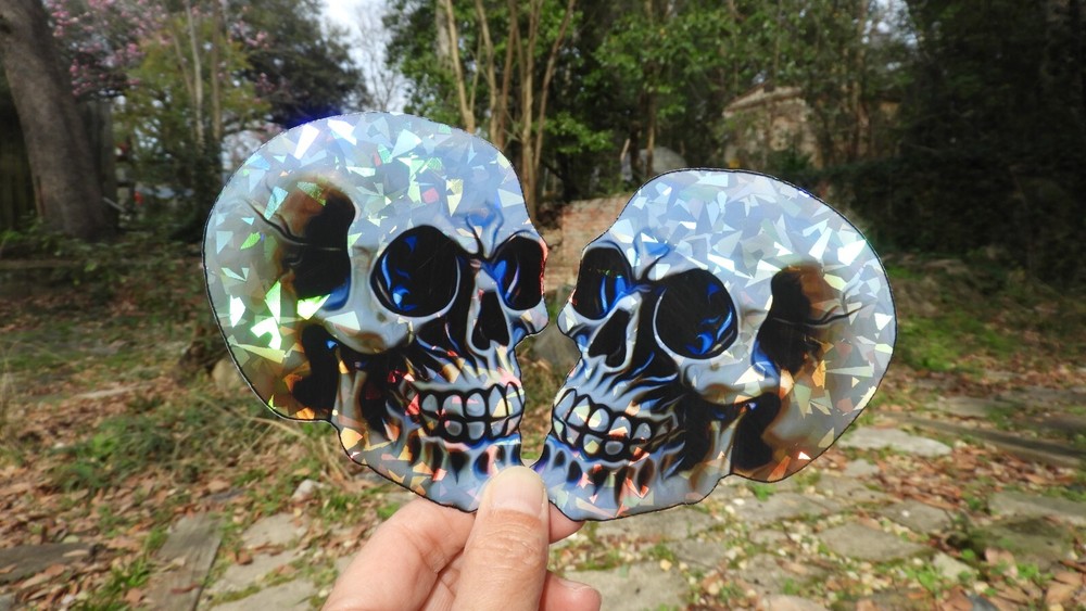 Pack of 2 – 4″ HOLOGRAPHIC Facing SKULLS Stickers BIG 4 inch skull STICKERS