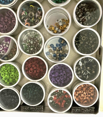 #1 – METAL CASE w/ 40 METAL CONTAINERS of SCRAPBOOKING EMBELLISHMENTS – EYELETS
