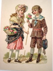 Sweet 1800’s Die Cut of Boy Handing Girl A small Bouquet of Two Pink Rose *