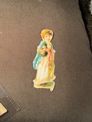 Adorable 1800’s Die Cut w/ Young Girl Carrying A Kitten w/ Princess Di Smile *
